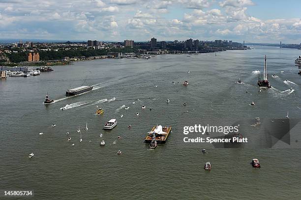 Flotilla surrounds NASA space shuttle Enterprise as it is carried by barge up the Hudson River on route to its permanent home at the Intrepid Sea,...