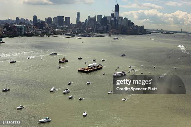 Flotilla surrounds NASA space shuttle Enterprise as it is carried by barge up the Hudson River on route to its permanent home at the Intrepid Sea,...