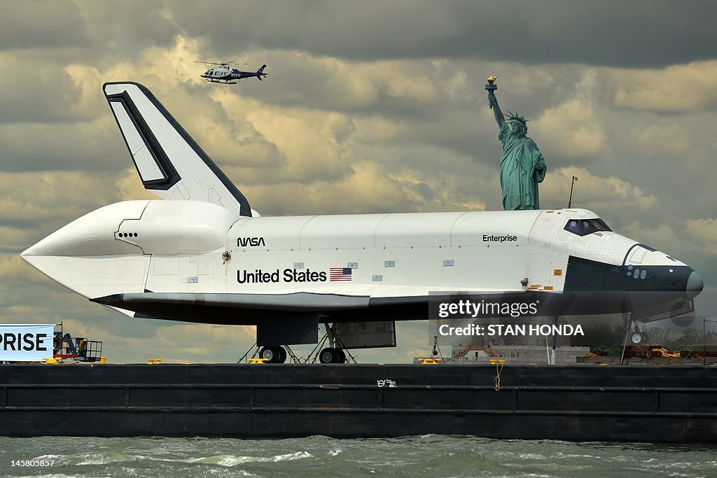 The space shuttle Enterprise is towed by