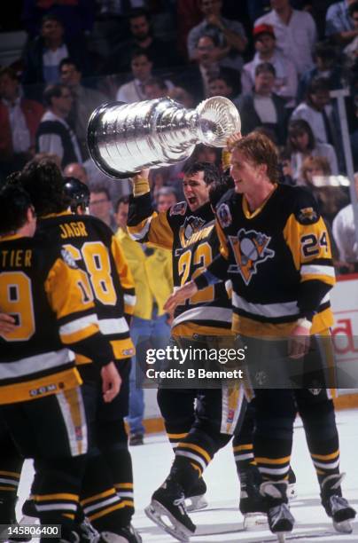 Ron Francis of the Pittsburgh Penguins skates on the ice with the Stanley Cup after Game 4 of the 1992 Stanley Cup Finals against the Chicago...