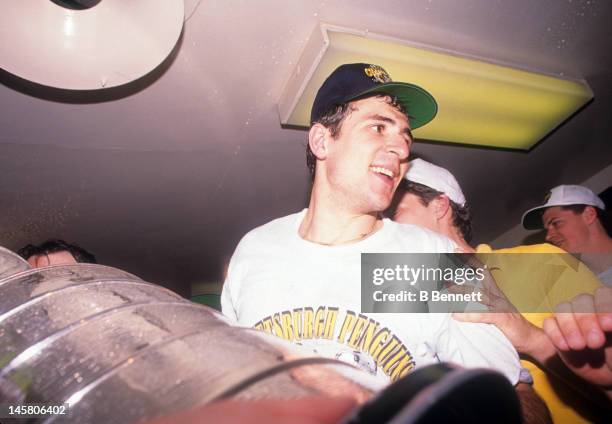 Ron Francis of the Pittsburgh Penguins celebrates in the locker room with the Stanley Cup after Game 4 of the 1992 Stanley Cup Finals against the...