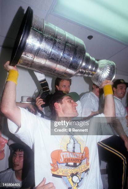 Ron Francis of the Pittsburgh Penguins celebrates in the locker room with the Stanley Cup after Game 6 of the 1991 Stanley Cup Finals against the...