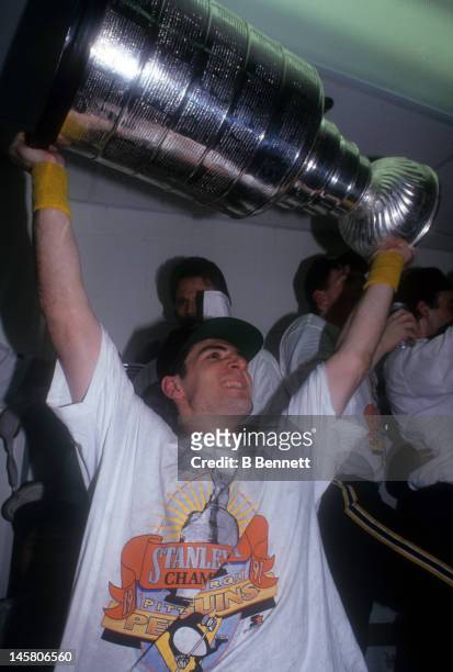 Ron Francis of the Pittsburgh Penguins celebrates in the locker room with the Stanley Cup after Game 6 of the 1991 Stanley Cup Finals against the...