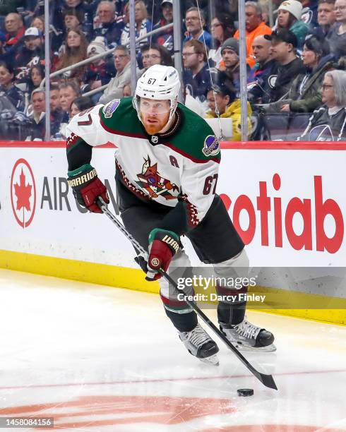 Lawson Crouse of the Arizona Coyotes plays the puck around the boards during first period action against the Winnipeg Jets at the Canada Life Centre...