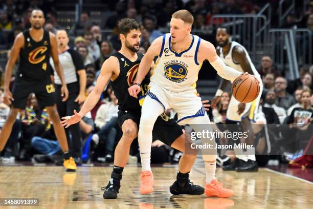 Raul Neto of the Cleveland Cavaliers guards Donte DiVincenzo of the Golden State Warriors during the second half at Rocket Mortgage Fieldhouse on...