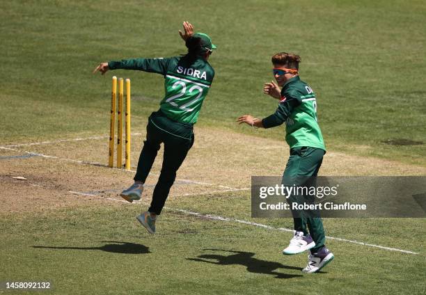 Sidra Amin and Nida Dar of Pakistan celebrate the wicket of Ashleigh Gardner of Australia during game three of the Women's One Day International...