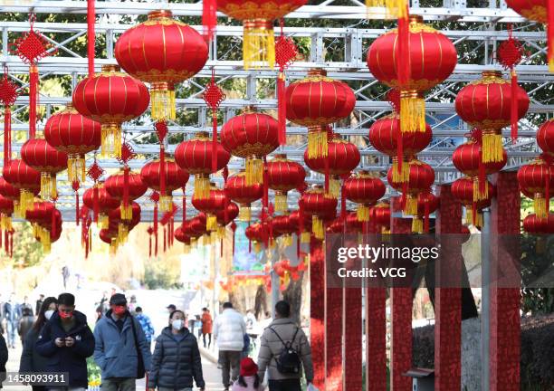 Tourists visit green lake park decorated red lanterns ahead of the Chinese New Year, the Year of the Rabbit, on January 20, 2023 in Kunming, Yunnan...