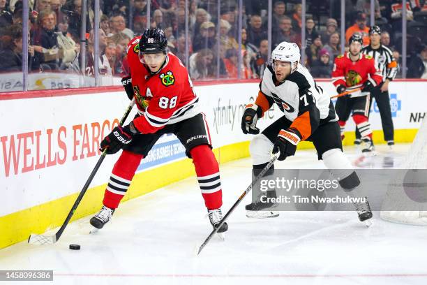 Patrick Kane of the Chicago Blackhawks skates with the puck past Tony DeAngelo of the Philadelphia Flyers at Wells Fargo Center on January 19, 2023...