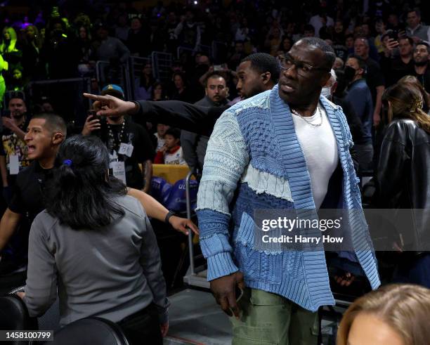 Shannon Sharpe reacts after he is restrained by security from Ja Morant of the Memphis Grizzlies after a verbal altercation after the first half...