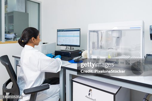 Female Scientist working in Laboratory using computer software analysing the sample testing result. Female Scientist working in Laboratory using computer software analysing the sample testing result.