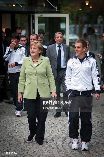 German Chancellor Angela Merkel and Germany's national football team captain Philipp Lahm arrive for a dinner with the German national footbal team...