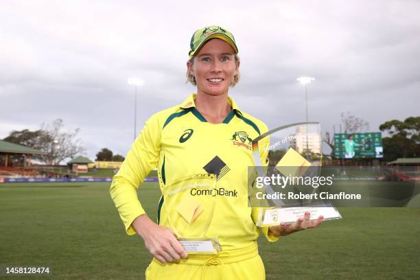 Beth Money poses with the player of the series and player of the match trophies during game three of the Women's One Day International Series between...