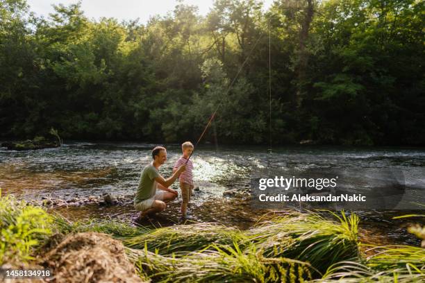 father and son fishing together - father sun stock pictures, royalty-free photos & images