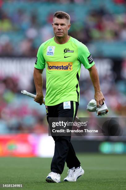 David Warner of the Thunder warms up prior to the Men's Big Bash League match between the Sydney Sixers and the Sydney Thunder at Sydney Cricket...