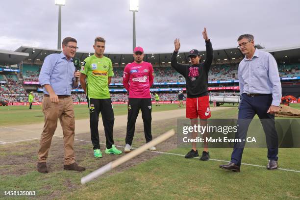 Captains, Chris Green of the Thunder and Moises Henriques of the Sixers watch the bat flip during the Men's Big Bash League match between the Sydney...