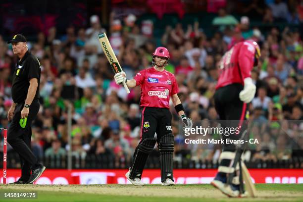 Steve Smith of the Sixers raises his bat to the crowd after reaching his half century during the Men's Big Bash League match between the Sydney...