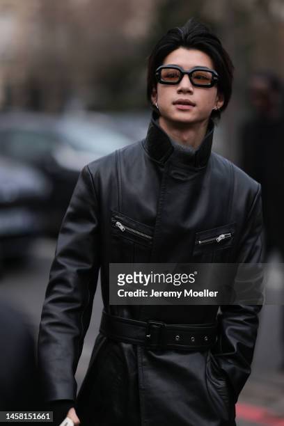 Fashion week guest seen wearing a black leather coat and dark shades before the Rick Owens show on January 19, 2023 in Paris, France.