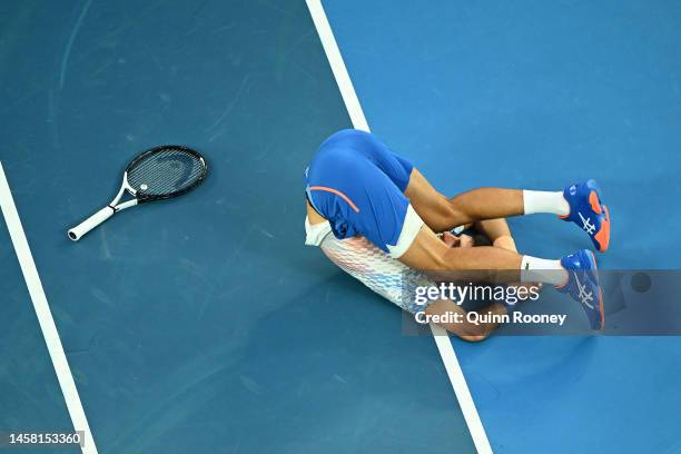 Novak Djokovic of Serbia falls during the third round singles match against Grigor Dimitrov of Bulgaria during day six of the 2023 Australian Open at...