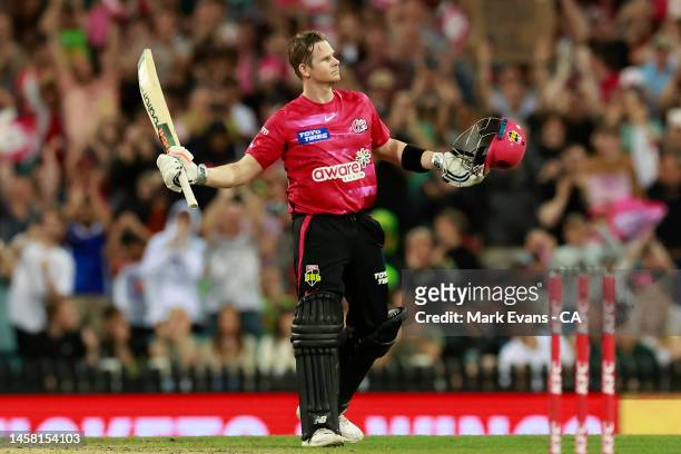 Steve Smith of the Sixers raises his bat to the crowd after reaching his century during the Men's Big Bash League match between the Sydney Sixers and...