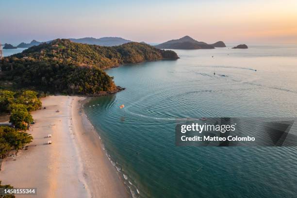 aerial view of pantai cenang beach and islands at sunset, langkawi - pulau langkawi stock pictures, royalty-free photos & images