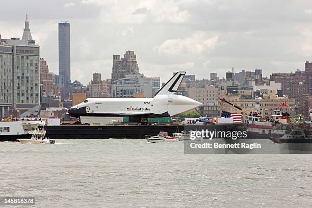 The Space Shuttle Enterprise as seen from the New Jersey side of the Hudson River is transported to the Intrepid Sea, Air & Space Museum on June 6,...
