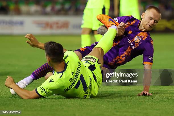 Chris Ikonomidis of the Victory strikes Jack Clisby of the Glory with his right boot during the round 13 A-League Men's match between Perth Glory and...