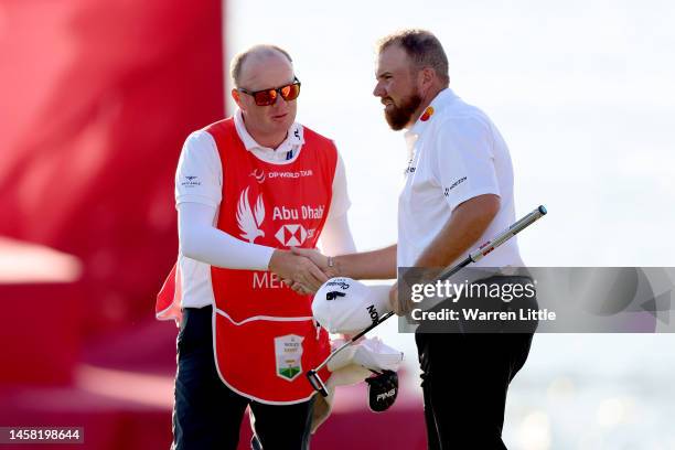 Shane Lowry of Ireland shake hands with Adrian Meronk Caddie after finishing his round on 18th hole during day three of the Abu Dhabi HSBC...