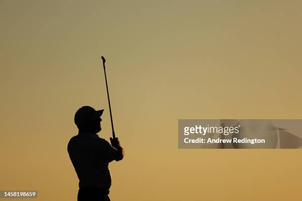 Silhouette as Francesco Molinari of Italy plays his third shot on the eighteenth hole during day three of the Abu Dhabi HSBC Championship at Yas...