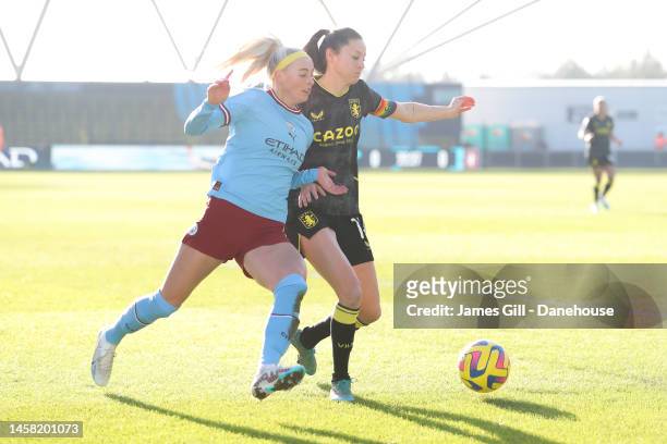 Chloe Kelly of Manchester City battles for possession with Danielle Turner of Aston Villa during the FA Women's Super League match between Manchester...