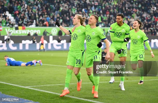 Patrick Wimmer of VfL Wolfsburg celebrates after scoring the team's first goal with teammate Yannick Gerhardt during the Bundesliga match between VfL...