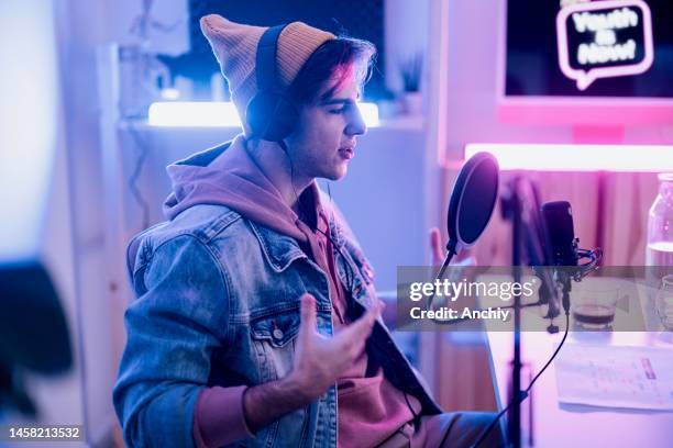 close up of a male radio show hosts record podcast episode in home studio - television host stock pictures, royalty-free photos & images