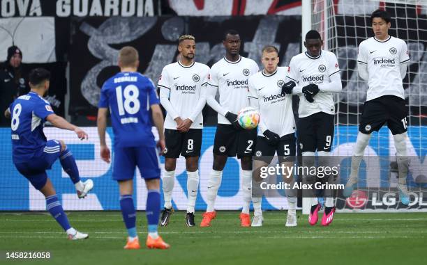 Maximilian Eggestein of SC Freiburg takes a free kick, as players of Eintracht Frankfurt form a wall, during the Bundesliga match between Eintracht...