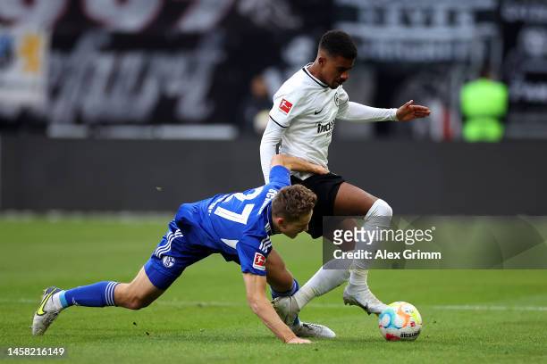 Ansgar Knauff of Eintracht Frankfurt is challenged by Cedric Brunner of FC Schalke 04 during the Bundesliga match between Eintracht Frankfurt and FC...