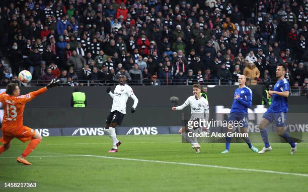 Jesper Lindstrom of Eintracht Frankfurt scores the team's first goal as Alexander Schwolow of FC Schalke 04 attempts to make a save during the...