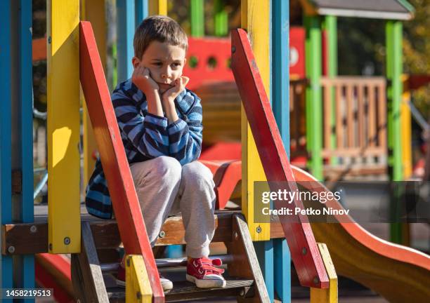 sad boy at the playground - friends loneliness imagens e fotografias de stock