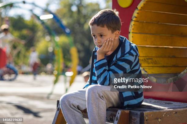 sad boy at the playground - one boy only stock pictures, royalty-free photos & images