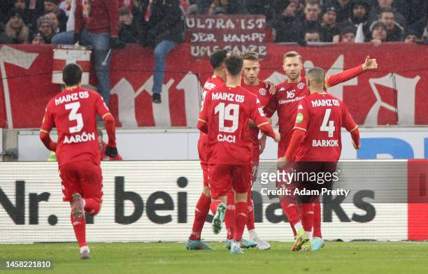 Marcus Ingvartsen of 1.FSV Mainz 05 celebrates after scoring the team's first goal from a penalty with teammates during the Bundesliga match between...