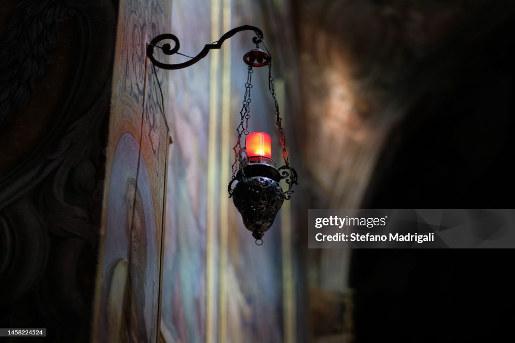 Red lampion with hanging candle in church