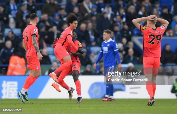 Kaoru Mitoma of Brighton & Hove Albion celebrates after scoring the team's first goal while knocking down teammate Moises Caicedo during the Premier...