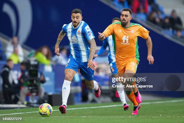 Joselu of RCD Espanyol runs with the ball whilst under pressure from Borja Iglesias of Real Betis during the LaLiga Santander match between RCD...