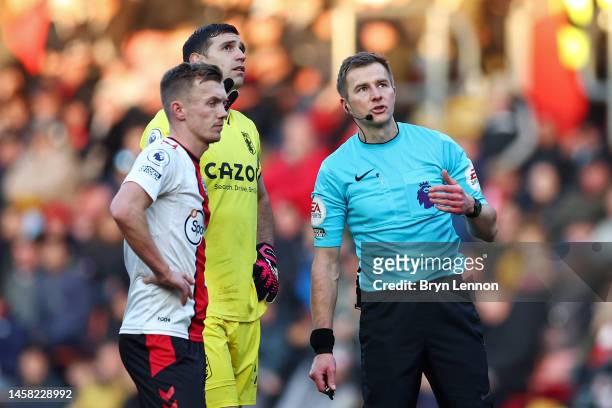 Referee Michael Salisbury reacts as the game is paused due to a drone flying above the pitch during the Premier League match between Southampton FC...