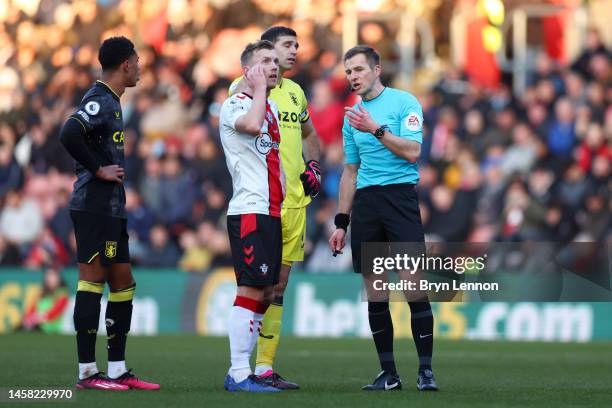 Referee Michael Salisbury reacts as the game is paused due to a drone flying above the pitch during the Premier League match between Southampton FC...