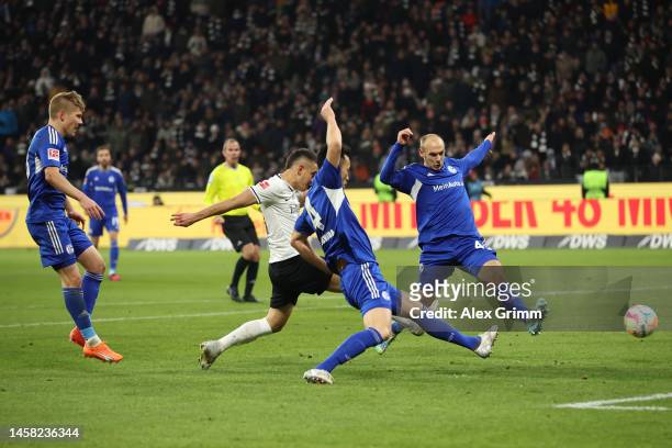 Rafael Santos Borre of Eintracht Frankfurt scores the team's second goal whilst under pressure from Maya Yoshida and Henning Matriciani of FC Schalke...