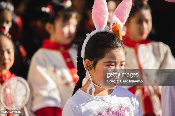 Girl, with bunny ears, attends the Chinese New Year Parade on January 21, 2023 in Barcelona, Spain. The Chinese community in Barcelona celebrates the...