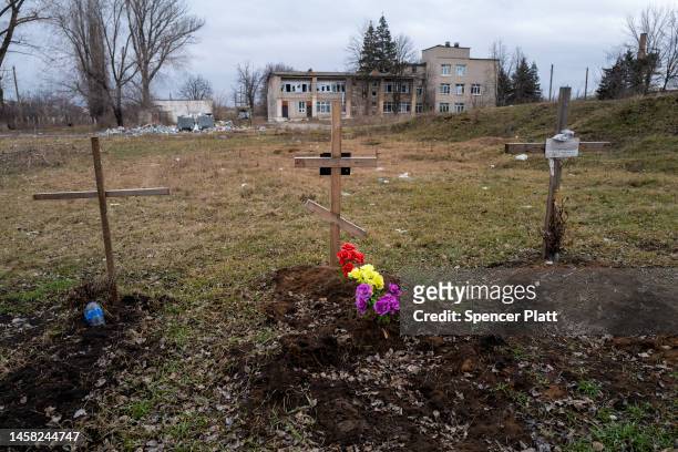 Newly dug graves stand in a field beside a hospital in the heavily damaged town of Siversk which is situated near the front lines with Russia on...