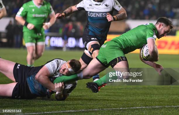 Falcons player Michael Young breaks the tackle of Shane Delahunt to score the opening try during the Pool A Challenge Cup match between Newcastle...