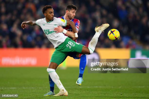 Joe Willock of Newcastle United is challenged by during the Premier League match between Crystal Palace and Newcastle United at Selhurst Park on...