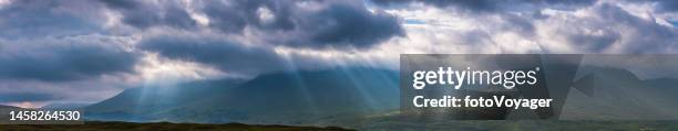 scotland rays of sunlight beaming onto rannoch moor highlands mountains - the trossachs stock pictures, royalty-free photos & images