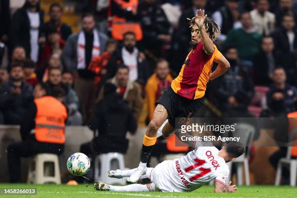 Sacha Boey of Galatasaray SK is challenged by Guray Vural of Antalyaspor during the Super Lig match between Galatasaray SK and Antalyaspor at the NEF...