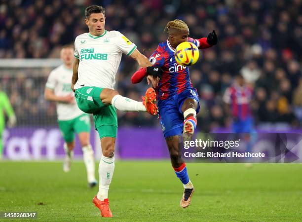 Fabian Schar of Newcastle United battles for possession with Wilfried Zaha of Crystal Palace during the Premier League match between Crystal Palace...